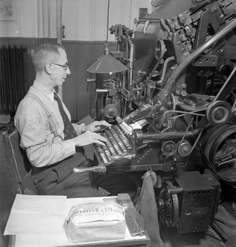 Operarios trabajando con una máquina Linotype en un taller de composición tipográfica.